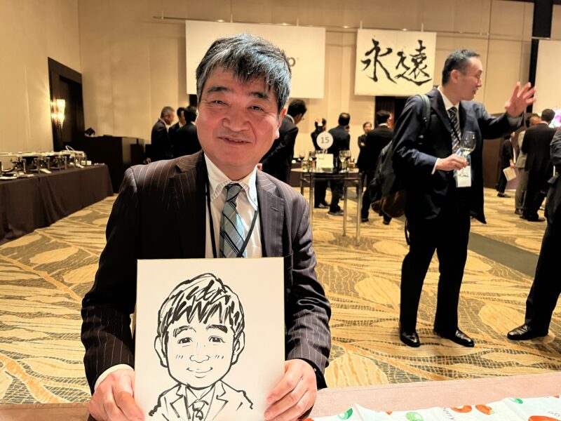 企業パーティーでお一人約3分の早描き似顔絵を楽しむお客様